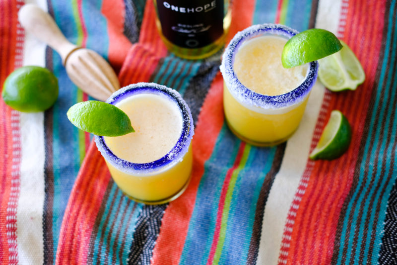 two margaritas on a picnic blanket