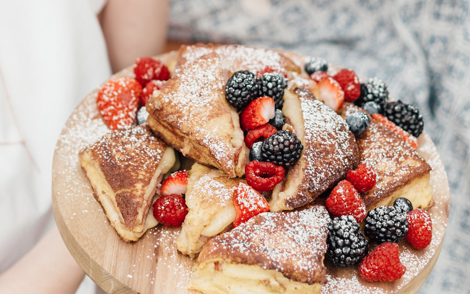 Plate of Monte Cristo's with dusting of powder sugar and berries